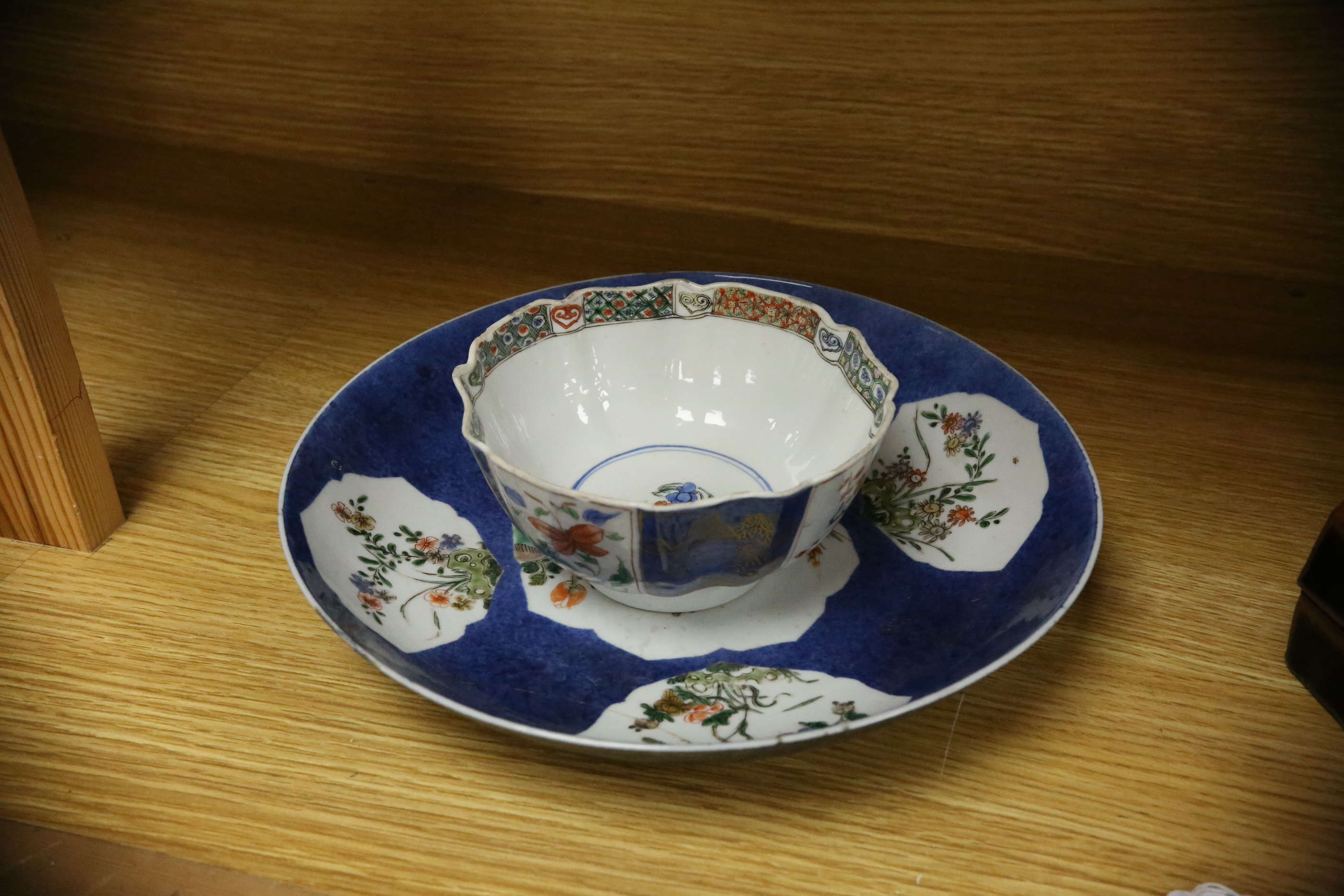 A Chinese famille verte powder blue ground bowl and a similar dish, both Kangxi period, 27.5cm diameter. Condition - dish poor, bowl fair